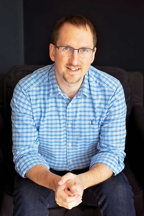 Mike Cole sitting on a chair looking into the camera