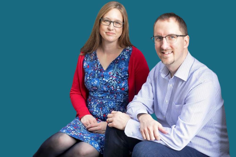 Mike and Liz sat on a step, looking up at the camera